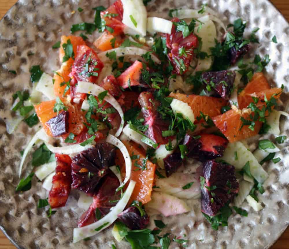 Top view of blood orange and fennel salad on a plate.