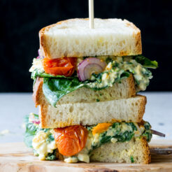 a cropped image of a delicious egg floretine toasted sandwich with roasted tomatoes