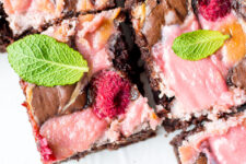 close up image of a cut rapsberry cheesecake brownies
