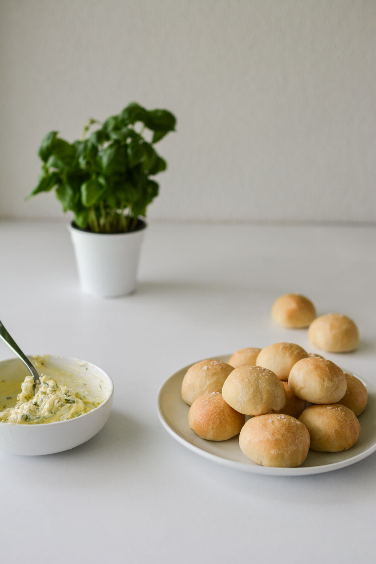a plate with neatly arranged bunches of doughballs accompanied by a bowl of dressing placed nearby