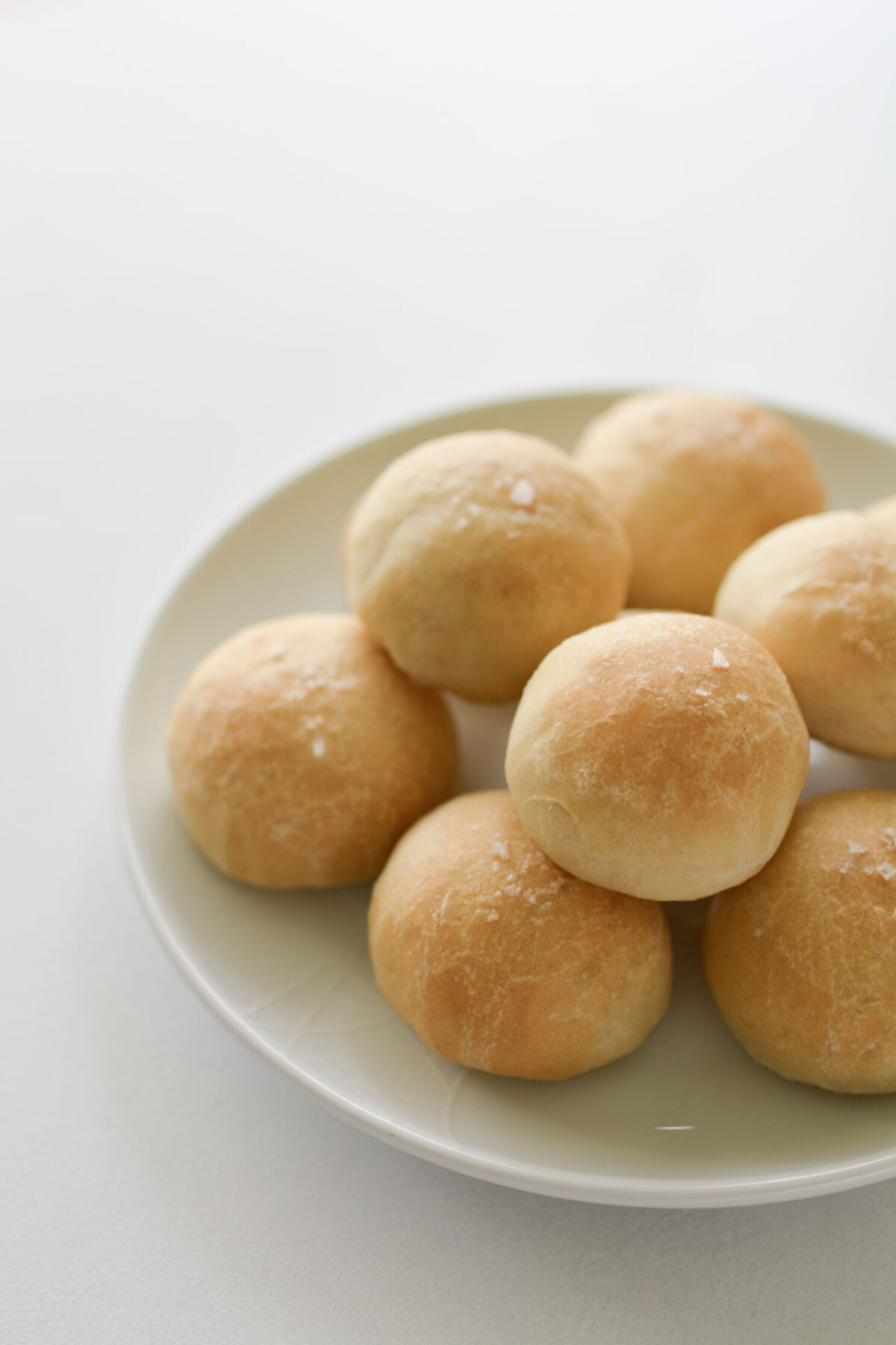 A close up image of a plate containing freshly bake doughballs.