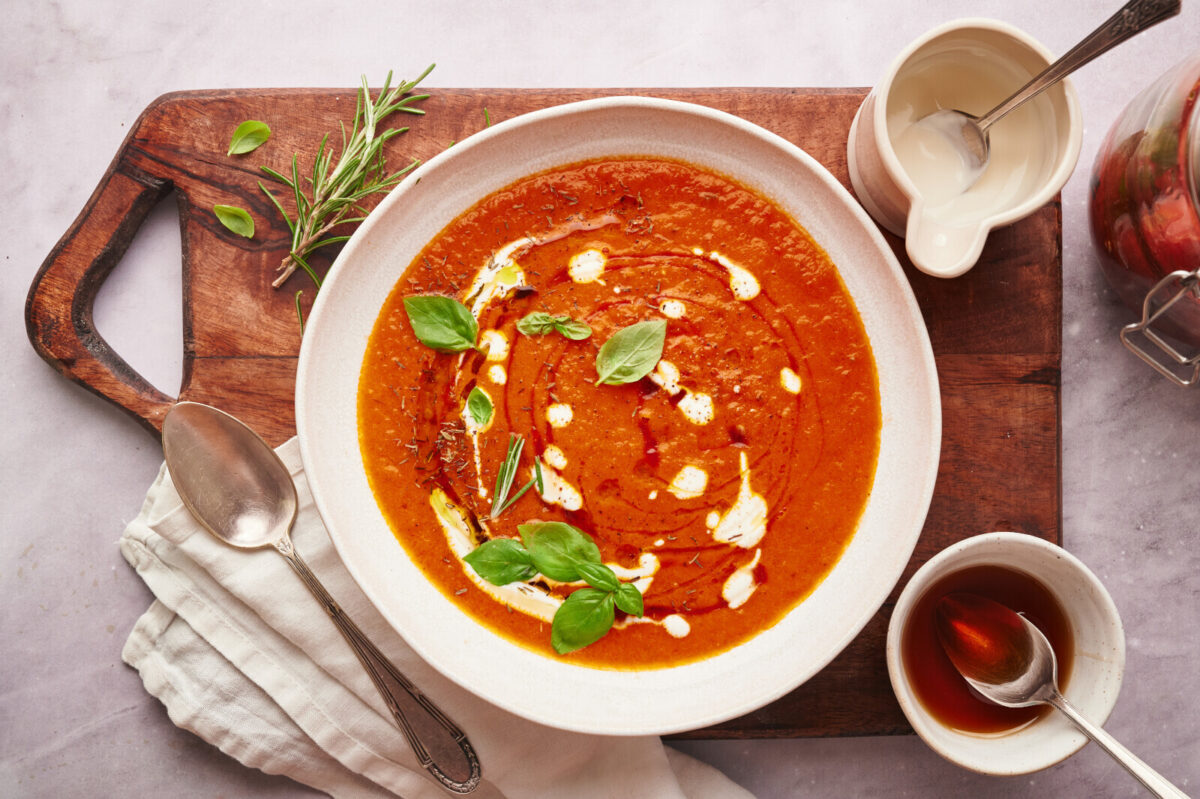 Roasted tomato soup garnished with basil, half and half, and maple syrup.