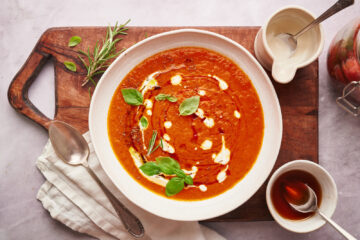 Roasted tomato soup garnished with basil, half and half, and maple syrup.