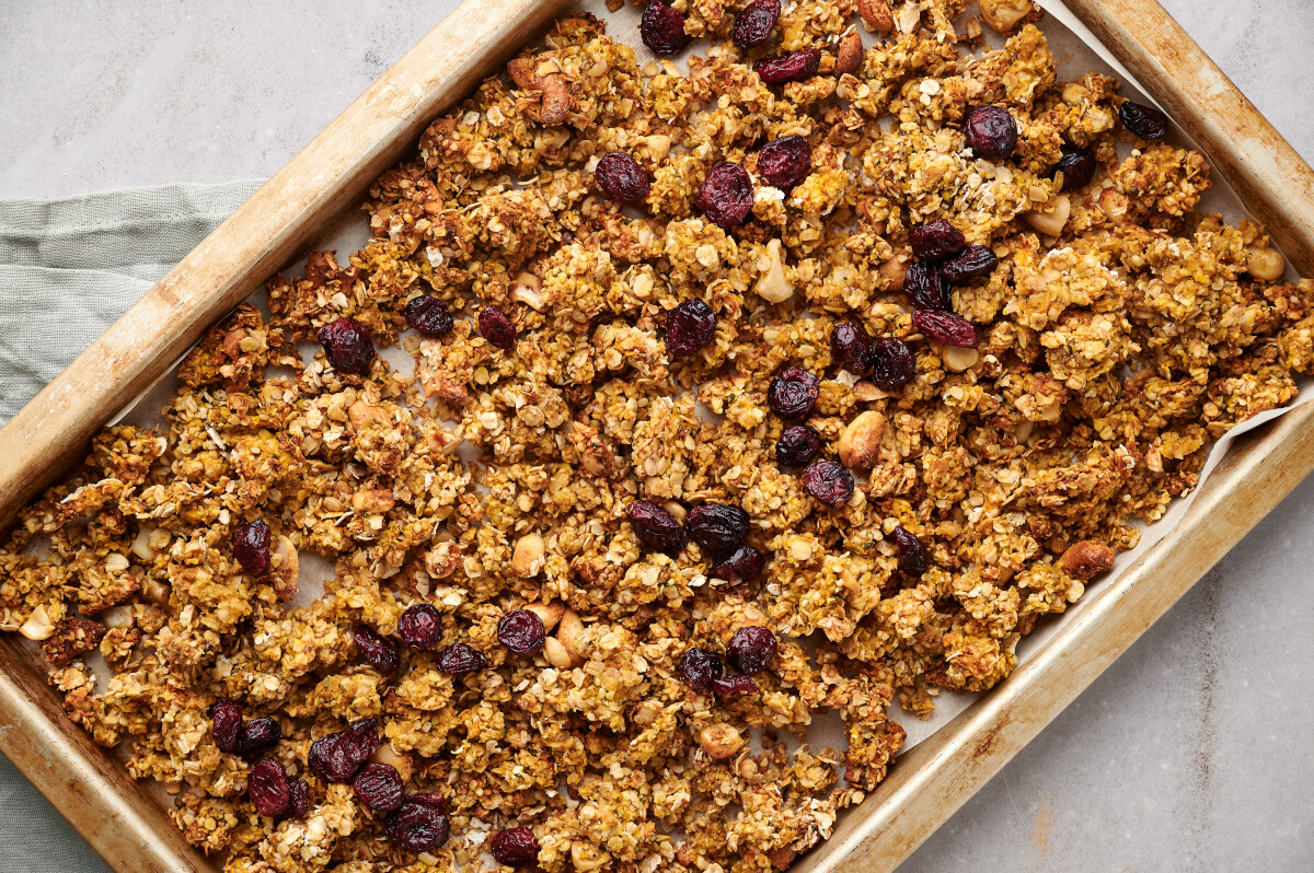 Baked Pumpkin Spice Granola on a parchment lined baking sheet.