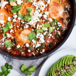 Shakshuka with Spinach in a wok topped with feta cheese.